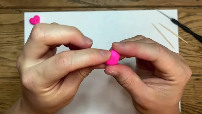 Continue smoothing the edges, pulling your finger along the surface to achieve a smooth finish. The clay is forgiving, so don't be afraid to make adjustments.