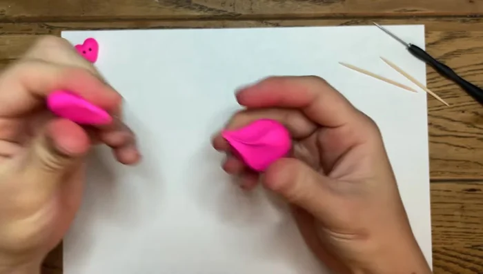 Take a desired amount of clay and warm it up to prevent cracking in the oven. Roll it into a ball.