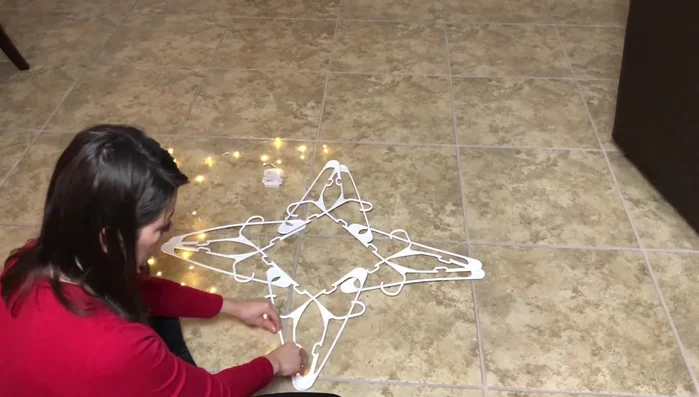 Wrap string lights around the star structure.