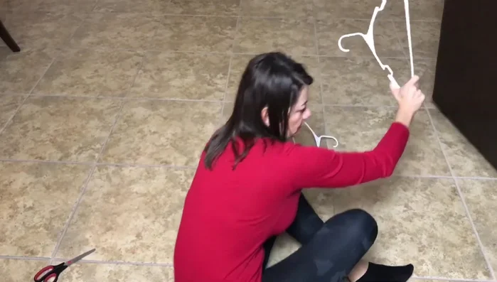 Interlock hangers: Bring one hanger's hook over another's hook, then the next under and over.