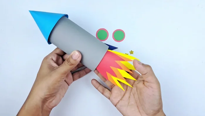 Glue the flame shapes to the bottom of the rocket.