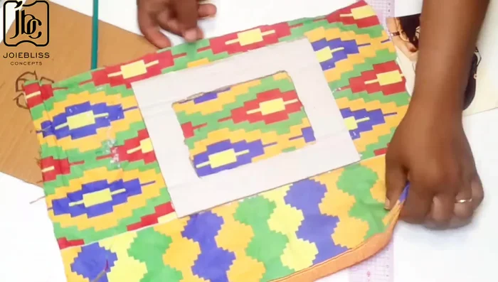 Cover cartons with fabric, trim excess fabric.