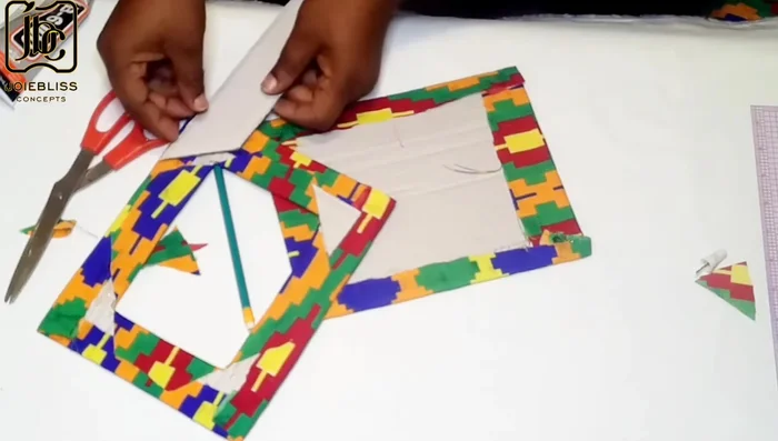 Cut out small triangle shapes to create openings for the picture to fit in.