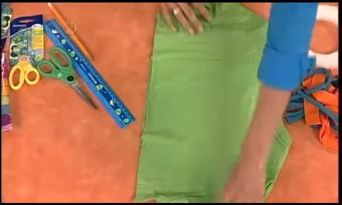 Open up the loops and pull the piece between your hands to curl the strips.