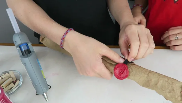 Roll up the map and secure it with the ribbon and seal.