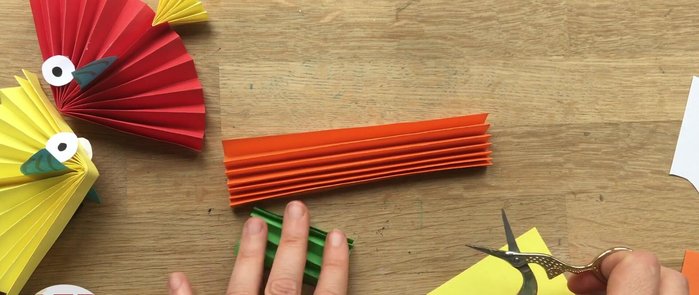 Cut the fin: Cut a semicircle from the larger folded paper to form the fish's fin. Add small markings to create a more detailed fin.