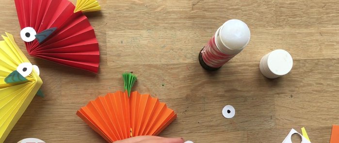 Add the eyes: Apply glue to the back of the eyes and attach them to the fish's body.