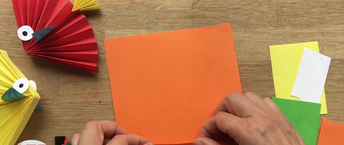 Create the fan: Fold the larger square into a series of accordions, keeping a straight edge along the bottom. Repeat with the smaller square for the tail.