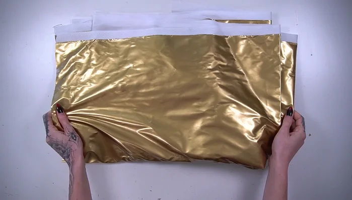 Cut, fold, and glue the edges of the fabric to create a clean finish.