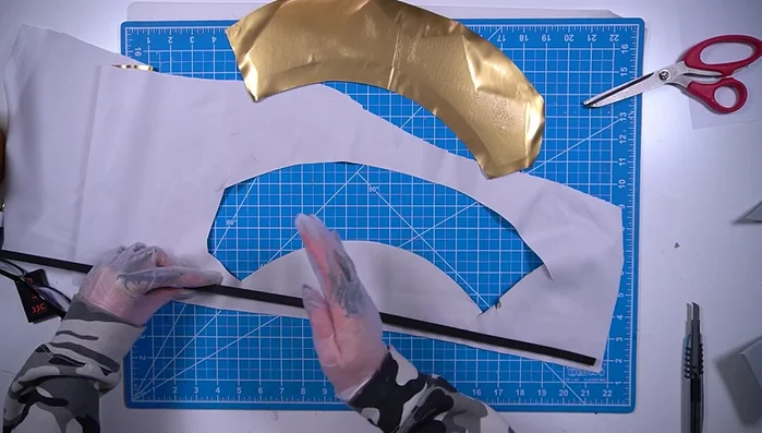 Cover an EVA foam half dowel with gold fabric and glue it to the bottom edge of the crown.
