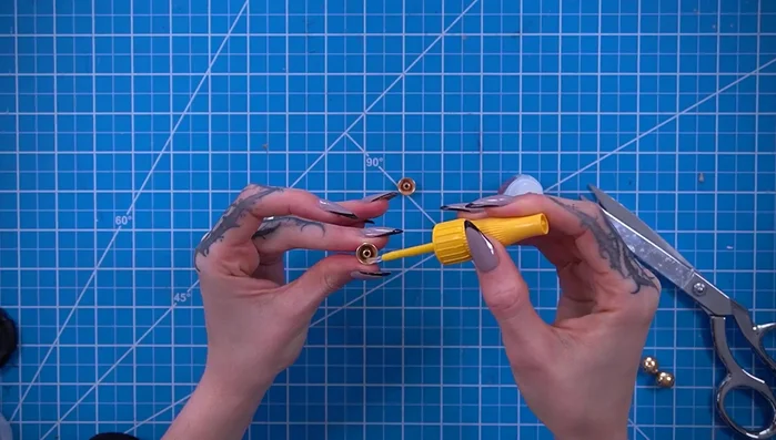 Sculpt and attach small eyes using DecoArt thermoplastic beads, a heat gun, and black paint.