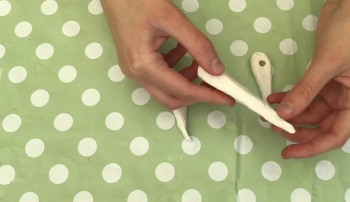 Paint the pieces: Use various colors of paint to create realistic-looking Stone Age jewelry. The narrator suggests a mix of brown, yellow, white, pink and blue.