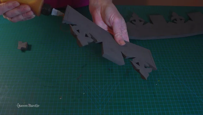 Glue together the pointed and flat ends of the pentagons to the crown base.