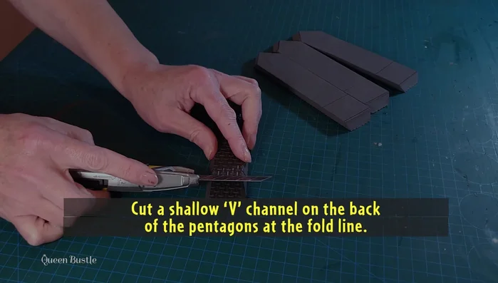 Glue together the pointed and flat ends of the pentagons to the crown base.