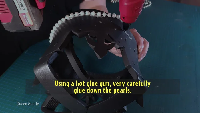 Glue gems and crystals to the crown according to the layout.