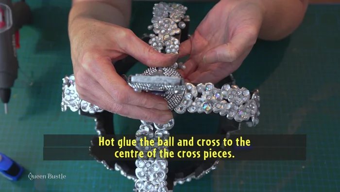 Glue the polystyrene ball and cross to the center of the cross pieces.