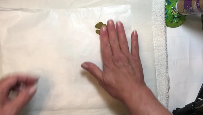 Place your dried leaves (or other thin materials) between two sheets of wax paper, with the shiny side of the wax paper facing the items.