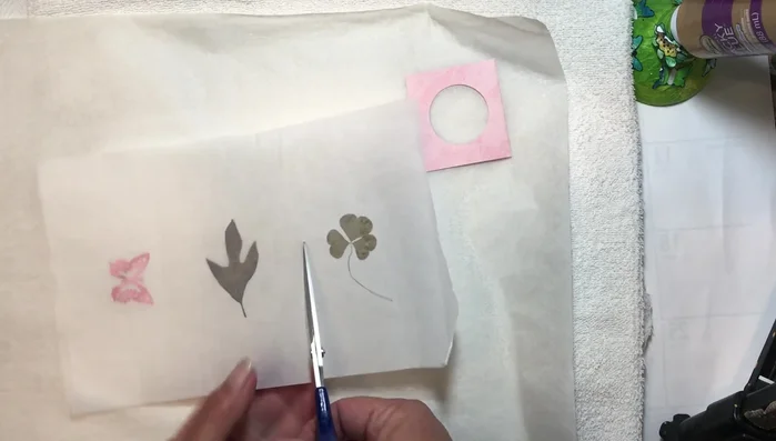 Cut out the desired shape around your pressed element, leaving a border of wax paper.