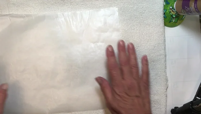 Prepare your workspace: Place a towel on your table (or use an ironing board). Cover with parchment paper to protect the surface.