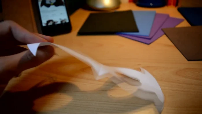 Cut out the paper template. Draw half the design, fold the paper, and cut to ensure symmetry.