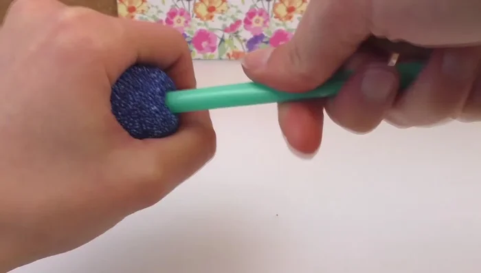 Twist the straw to create a hole for hanging.