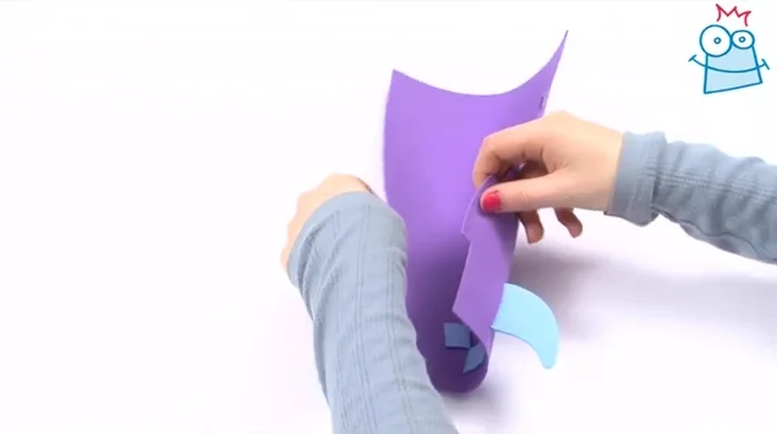 Bend the large foam shape into a cylinder, feeding the two side tabs through pre-cut slots.