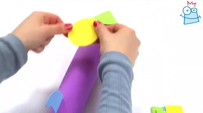 Decorate the rocket using the foam stickers included in the kit. (Example: Yellow circle, blue SWR sticker, yellow star, green spots).