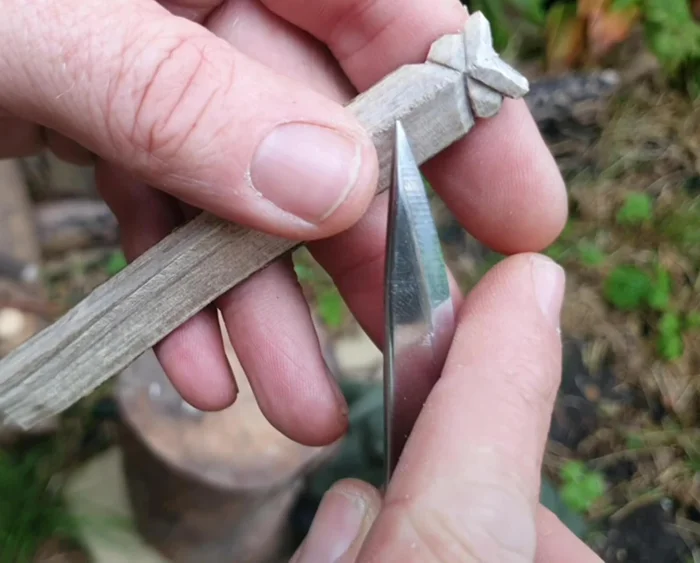 Separate the body from the tail: Score a line to separate the owl's body from the tail. Deepen the score cut and carefully separate the two parts.