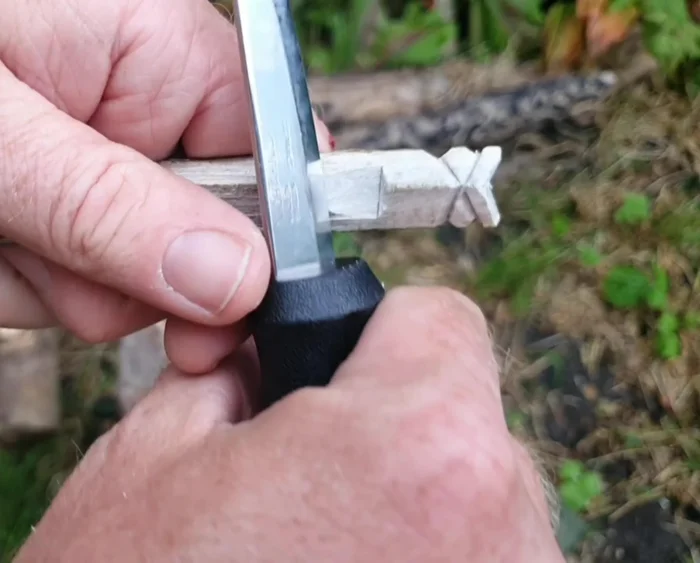 Shape the tail: Thin the top of the tail and curve the bottom half. Add notches to create a feathery effect.