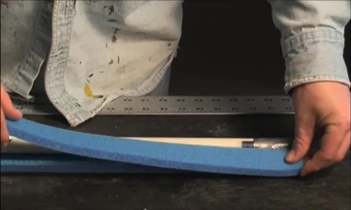 Continue applying contact cement and stacking the remaining 1in foam strips around the PVC core, creating a box shape. Trim excess foam.