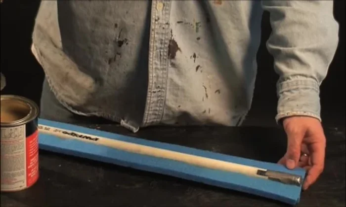 Continue applying contact cement and stacking the remaining 1in foam strips around the PVC core, creating a box shape. Trim excess foam.