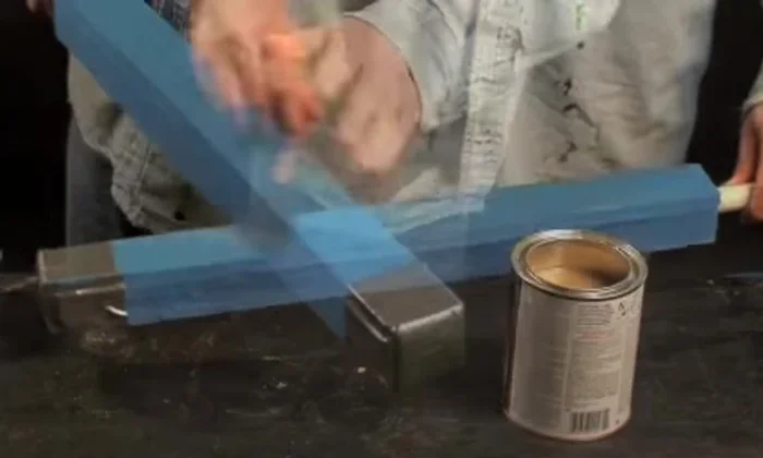 Attach a second blade (striking surface) over the first, maintaining firm pressure and securing with additional duct tape.