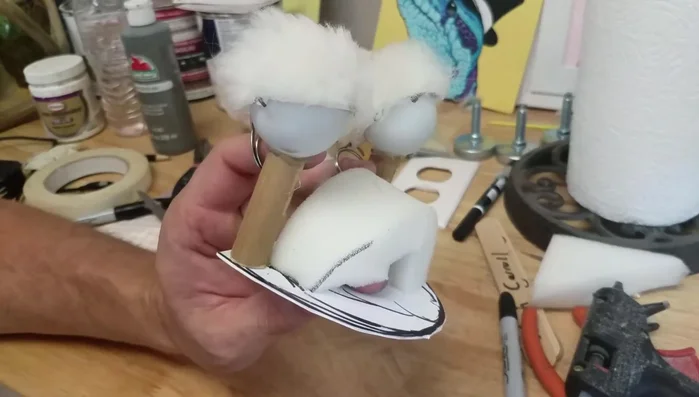 Create and attach a foam piece inside the mouth to secure fingers for eye operation.