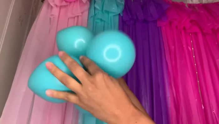 Balloon decoration (optional): Attach two balloons together, creating a flower shape with a string. Secure to the backdrop using additional string.