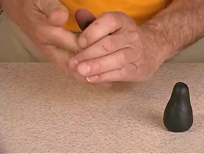 Sculpt the wings by rolling out black clay into a flat shape and cutting out two wing shapes.