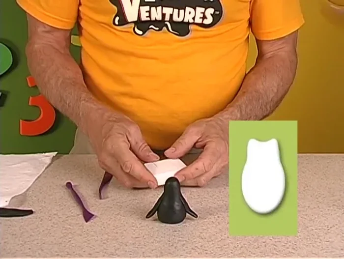 Attach the white chest patch to the penguin's body and smooth the edges.