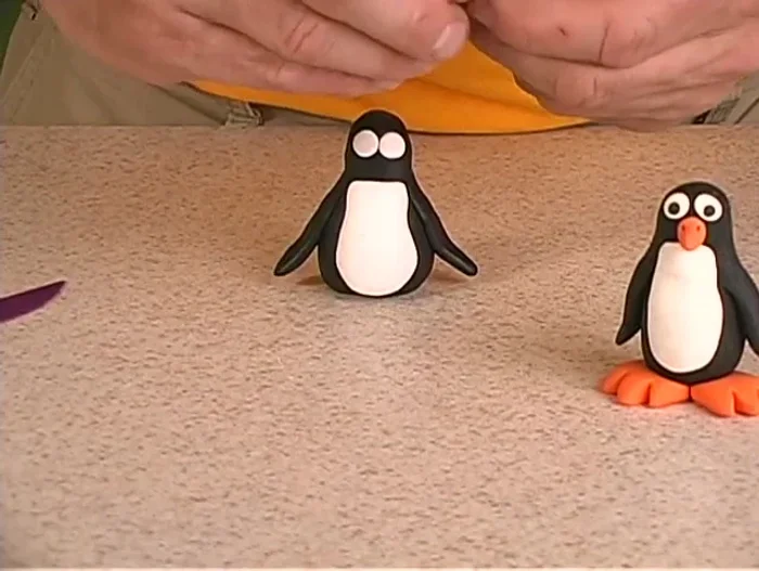 Create two tiny black dots for the pupils and attach them to the eyes.