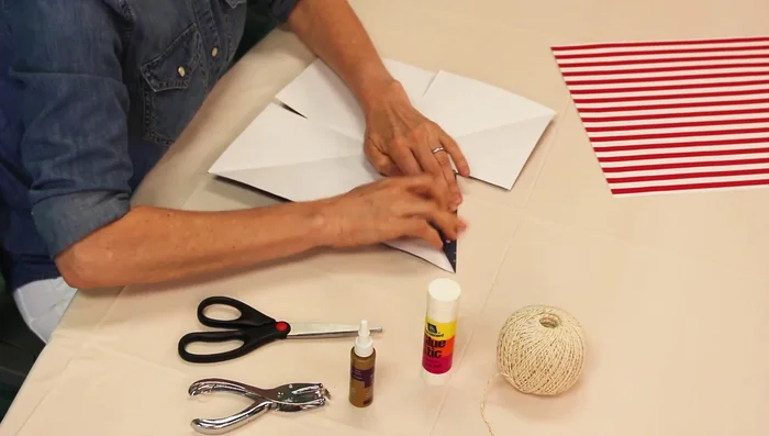 Fold in the sides of each cut to meet the diagonal fold line to create star points.