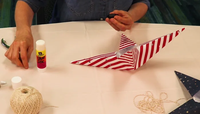 Peel the adhesive backing off the LED light and glue it inside one star's center.
