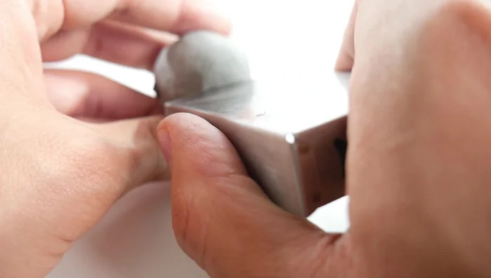 Create the mouth: Use a cutter to make a mouth line, then use a toothpick or pointed tool to create small holes at the corners for expression.