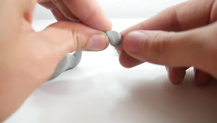 Attach the fins: Attach two comma-shaped pieces to the back for the tail fins, and two to the sides for the side fins.