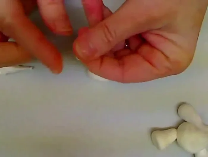 Add facial features: Attach a small purple ball for the nose. Use a toothpick to create eye sockets, and optionally add beads or simply make indentations for eyes and eyebrows.