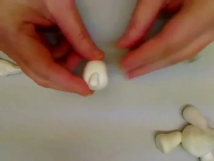 Add facial features: Attach a small purple ball for the nose. Use a toothpick to create eye sockets, and optionally add beads or simply make indentations for eyes and eyebrows.