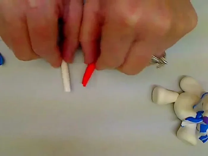 Make the candy cane: Twist together logs of red and white clay to create a candy cane stripe effect, then shape it and place it in the bear's lap.