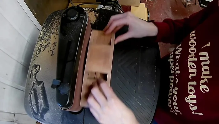 Perform final shaping using a belt sander and hand sanding.