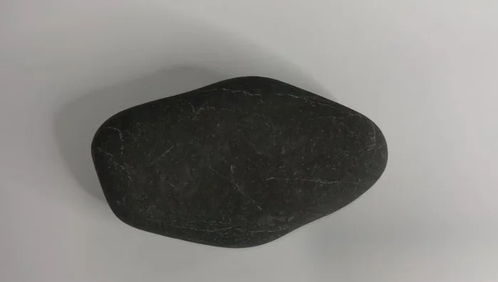 Wash the rock with warm soapy water, let it dry, and apply two base coats of white acrylic paint for vibrant colors.