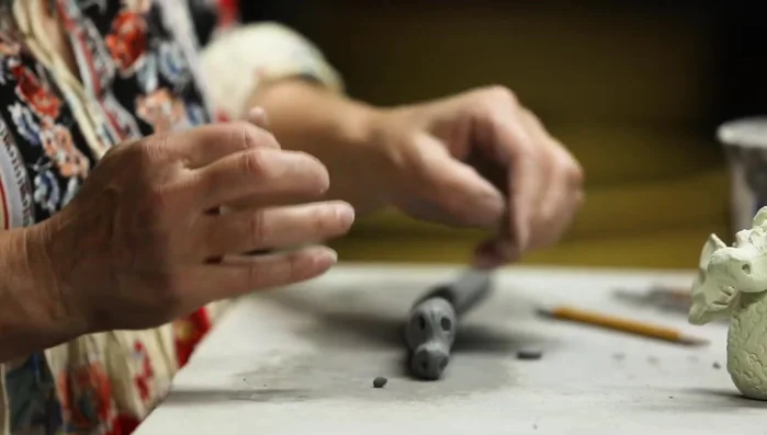 Add eyeballs by scoring and slipping the eye sockets.