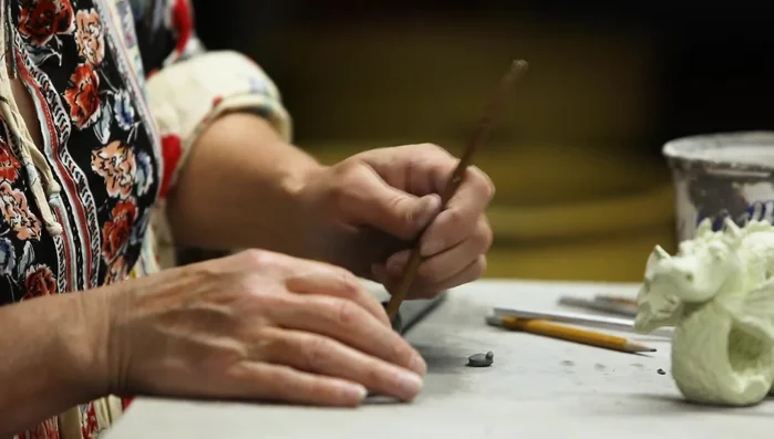 Apply texture using a piping tool or needle tool to mimic scales.