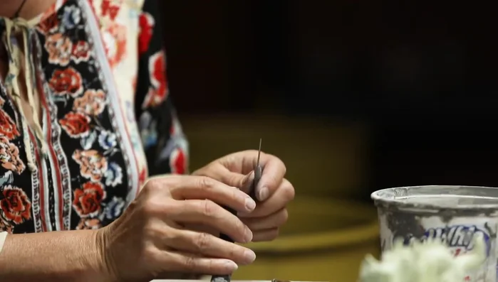 Use a needle tool to add details to the tail, creating a mermaid-like tail effect.