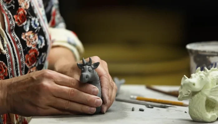 Broaden the base of the dragon to prevent it from tipping over.